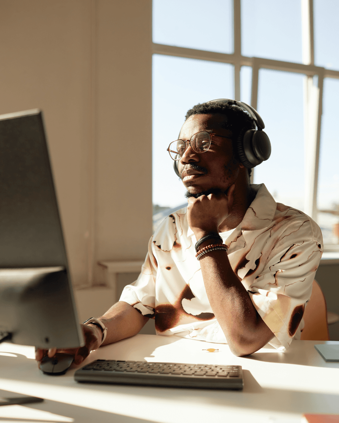 Person working at computer with headphones